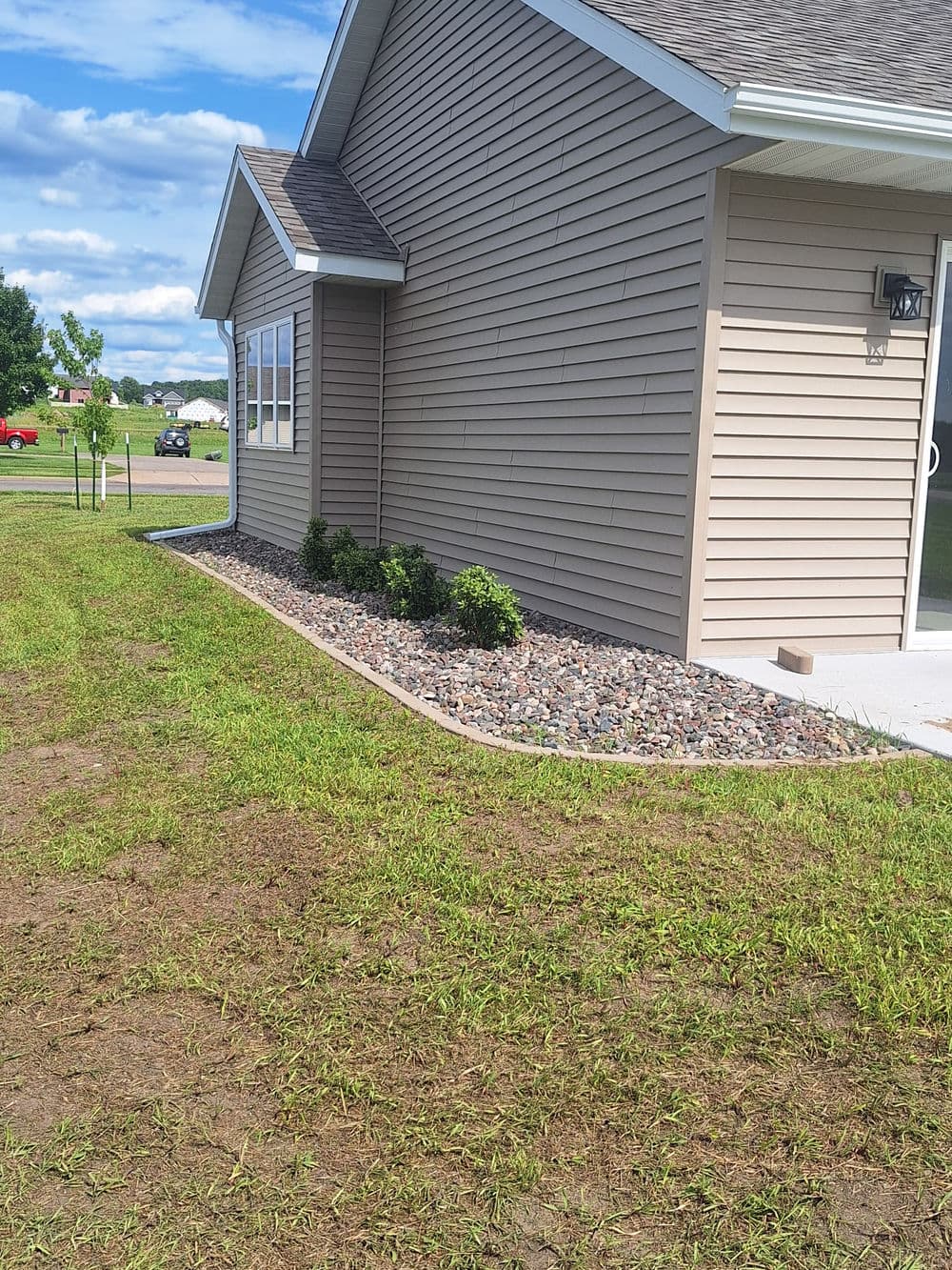 Concrete Landscape Edging and Rock Bed Installation in Fall Creek image